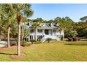 Two-story home with large front porch, mature landscaping, and palm trees at 1592 Boston Grill Road, Mount Pleasant, SC 29466