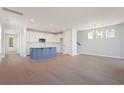 Open floor plan living area with kitchen island and hardwood floors at 300 Claret Cup Way, Charleston, SC 29414