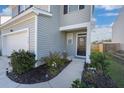 Two-story home's front entrance with black door and landscaping at 314 Black Birch Dr, Summerville, SC 29486
