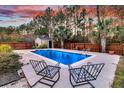 Relaxing pool area with two chairs and a wooden shed in the background at 319 Deep River Rd, Summerville, SC 29486