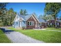 Blue and brick home with gravel driveway and green lawn at 118 Carter, Walterboro, SC 29488