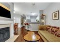 Living room with hardwood floors, fireplace, and a view into the kitchen at 2347 Tall Sail Dr # J, Charleston, SC 29414