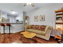 Living room features hardwood floors, a sofa, and a view to the kitchen at 2347 Tall Sail Dr # J, Charleston, SC 29414