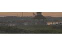 Gazebo on a pier overlooking calm water at sunset, with boats in the distance at 2347 Tall Sail Dr # J, Charleston, SC 29414