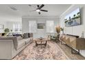 Spacious living room with a comfortable couch, a large TV, and wood floors at 496 Oak View Way, Summerville, SC 29483