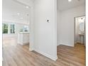 Bright hallway with wood-look floors, leading to living areas and powder room at 569 Trotters Ln # 222, Moncks Corner, SC 29461