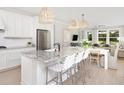 Spacious kitchen with white cabinets, granite countertops, and an island with seating at 763 Blue Iris Way, Summerville, SC 29486