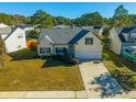 Attractive yellow house with a spacious yard, driveway, and attached garage at 111 Hollytree Cir, Ladson, SC 29456