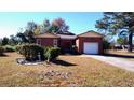 Brick ranch house with attached garage and mature landscaping at 153 Davis Ter, Saint George, SC 29477