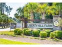 Liberty Hill Farm entrance sign with landscaping and palm trees at 1695 Cultivation Lane St # 463, Mount Pleasant, SC 29466