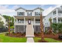 Two-story white house with a large front porch and landscaping at 1726 Cultivation Ln # 534, Mount Pleasant, SC 29466