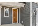 Elegant brown front door with sidelights, enhancing curb appeal at 422 Grove End Rd, Moncks Corner, SC 29461