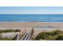 Wooden walkway to sandy beach with ocean view at 518 Ocean Blvd, Isle of Palms, SC 29451