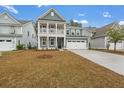 Two-story craftsman style home with gray siding, white trim, and a large front yard at 758 Maynard Ln, Summerville, SC 29486