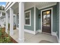 Inviting front porch with white columns and a dark brown front door at 758 Maynard Ln, Summerville, SC 29486