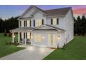 Two-story farmhouse-style home with white siding, dark shutters, and a front porch, nighttime view at 780 Maynard Ln, Summerville, SC 29486