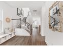 Bright and airy entryway with hardwood floors, built-in bench, and staircase at 1447 Clay Field Trl, Summerville, SC 29485