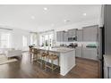 Modern kitchen with gray cabinets, granite countertops, and island at 1447 Clay Field Trl, Summerville, SC 29485