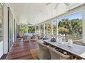 Relaxing screened porch with wicker furniture and dining area at 2220 Ion Ave, Sullivans Island, SC 29482