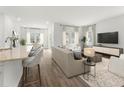 Open concept living space with kitchen island and hardwood floors at 319 Calm Water Way, Summerville, SC 29486