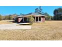 Brick home with covered carport at 388 E Main St, Harleyville, SC 29448