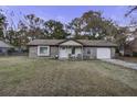 Brick ranch house with attached garage and a covered porch at 208 Janice St, Goose Creek, SC 29445