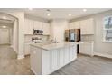 Modern kitchen with an island, stainless steel appliances, and light cabinets at 244 Mcmakin Dr, Summerville, SC 29483