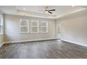 Spacious living room with three windows, hardwood floors, and a ceiling fan at 244 Mcmakin Dr, Summerville, SC 29483