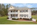 Two-story house with a detached garage, large yard, and driveway at 1129 Plantation Overlook Dr, Moncks Corner, SC 29461