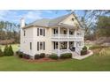Two-story house with wraparound porch and landscaped yard at 1129 Plantation Overlook Dr, Moncks Corner, SC 29461