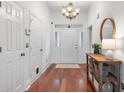 Light and airy entryway with hardwood floors and a round mirror at 116 Hearthstone Cir, Goose Creek, SC 29445