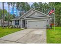 Gray house with 2-car garage and American flag, RV in background at 119 Osage Way, Summerville, SC 29483