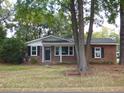 Charming brick ranch house with large trees in the front yard at 1278 S Lenevar Dr, Charleston, SC 29407