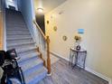 Bright entryway with staircase, grey flooring, and small table at 148 Pine Shadow Dr, Goose Creek, SC 29445