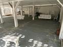 Relaxing covered patio with white wooden swing and seating at 2305 Myrtle St, Edisto Beach, SC 29438