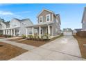 Two-story home with gray siding and a front porch at 282 Woodland Oak Way, Summerville, SC 29485