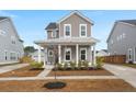 Gray siding two-story house with a front porch at 282 Woodland Oak Way, Summerville, SC 29485