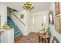 Bright entryway with hardwood floors, blue staircase, and decorative table at 46 Chadwick Dr, Charleston, SC 29407