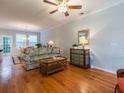 Hardwood floor living room with a floral sofa and a built-in cabinet at 1390 Hamlin Park Cir, Mount Pleasant, SC 29466