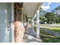 Covered side porch with brick and white columns at 301 Corey Blvd, Summerville, SC 29483