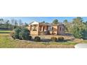 Brick home with covered porch and a landscaped yard at 3112 Santee River Rd, Saint Stephen, SC 29479