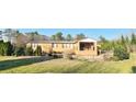 Brick home with covered porch and a landscaped yard at 3112 Santee River Rd, Saint Stephen, SC 29479