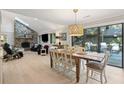 Open concept dining area with wood table and access to deck at 456 Vetch Ct, Kiawah Island, SC 29455