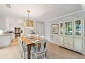 Bright dining area with farmhouse table and built-in hutch at 456 Vetch Ct, Kiawah Island, SC 29455