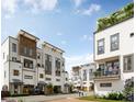 Townhomes with a tree-lined street, modern architecture, and people enjoying the outdoors at 1150 Valdosta St # 404, North Charleston, SC 29405