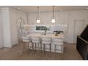 Modern white kitchen with an island, breakfast bar and gold accents at 1150 Valdosta St # 404, North Charleston, SC 29405