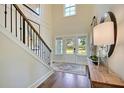 Bright two-story foyer with hardwood floors, featuring a staircase and front door at 117 Crosscut Ln, Summerville, SC 29486