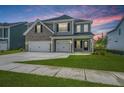 Two-story home with gray brick and siding, three-car garage, and landscaped yard at 117 Crosscut Ln, Summerville, SC 29486