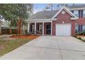 Brick townhouse with a front porch and driveway at 117 Venezia Ct, Ladson, SC 29456