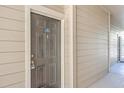 Close-up of apartment front door with keypad lock and light beige siding at 1600 Long Grove Dr # 914, Mount Pleasant, SC 29466